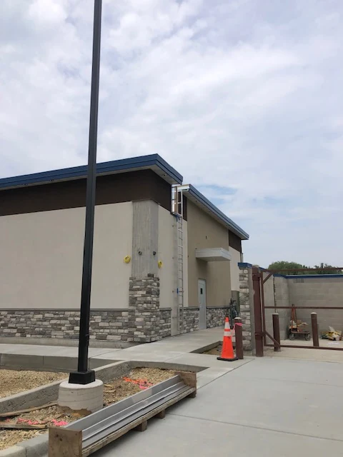Commercial building with tan stucco and stone veneer base