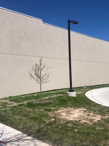Long commercial wall finished in tan stucco
