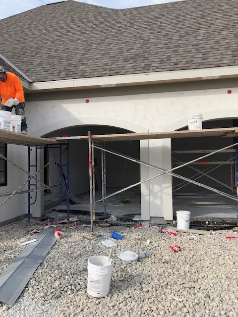 Skip trowel stucco finish on arched entry of custom home