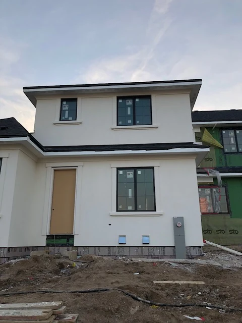 Two-story custom home with white synthetic stucco